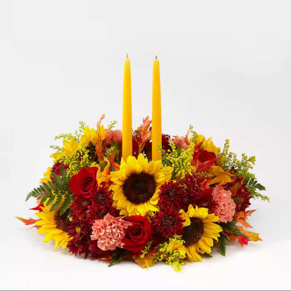 Autumn floral centerpiece with two yellow taper candles