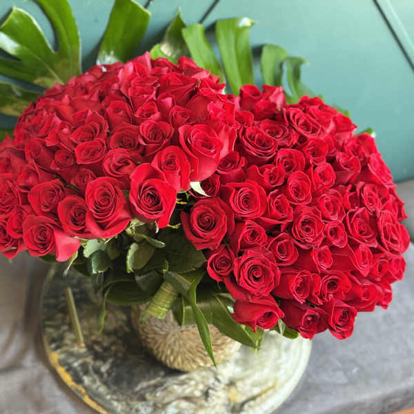 Large bouquet of red roses in a glass vase