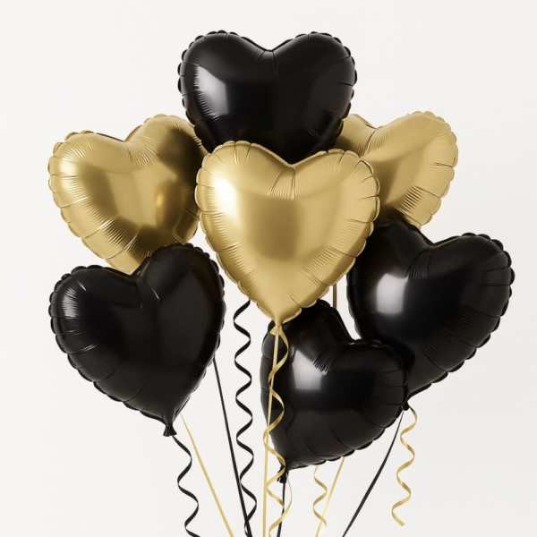 Cluster of black and gold heart-shaped balloons with curling ribbons