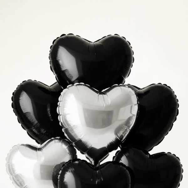 Cluster of black and white heart-shaped balloons