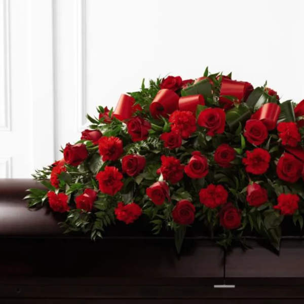 Red rose and carnation casket spray with ribbon