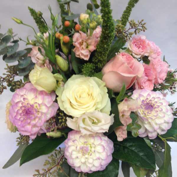Bouquet of pink and cream roses with lavender dahlias and greenery