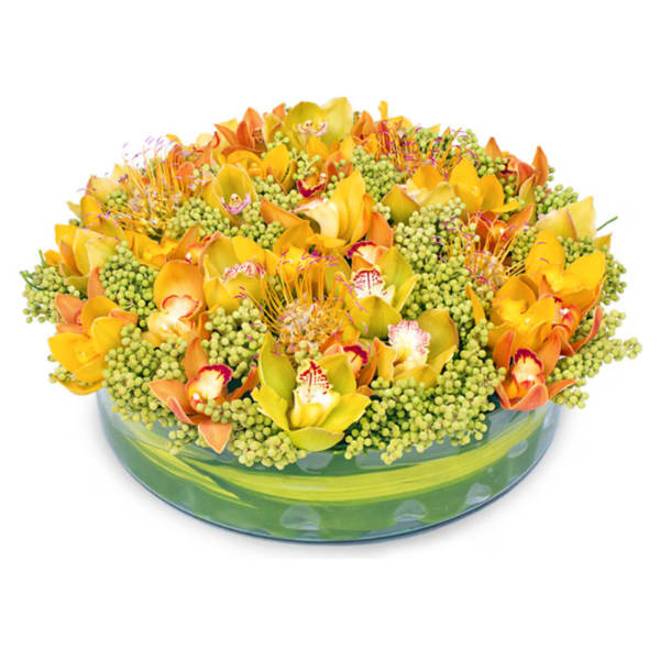 Yellow and orange orchid arrangement in a low glass bowl