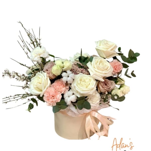 Cream and blush rose bouquet in a beige hatbox with a ribbon