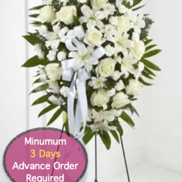 White funeral spray on a stand with ribbon