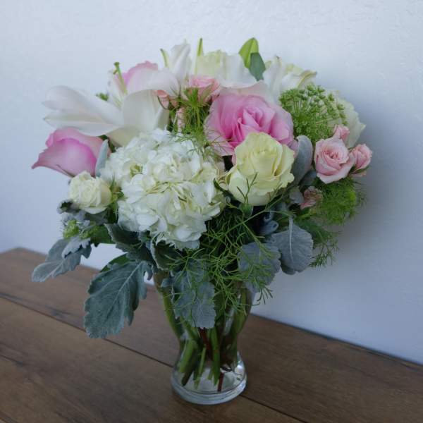 Pink and white bouquet in a clear glass vase