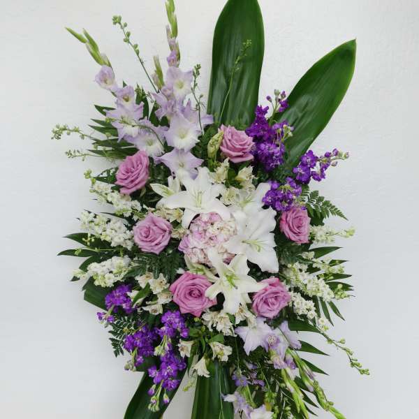 Standing floral spray with pink and white flowers on an easel