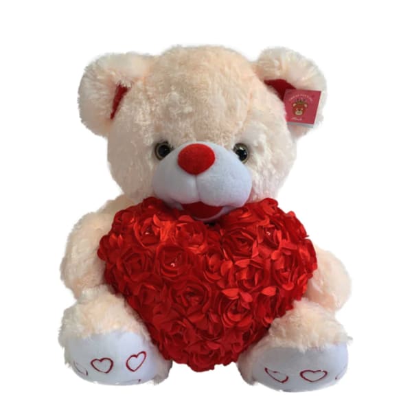 Plush teddy bear holding a red heart-shaped rose arrangement