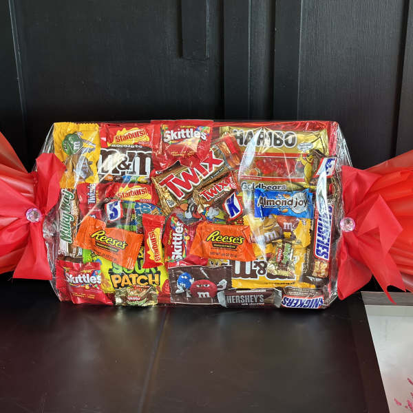 Wrapped candy gift basket with assorted chocolate and gummy bars