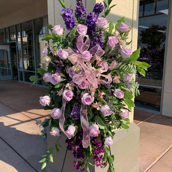 Tall standing floral spray with pink roses and purple flowers