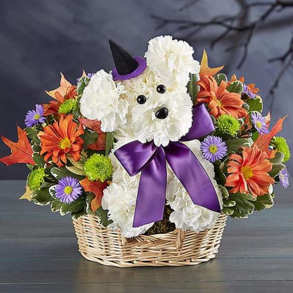Dog-shaped floral basket with white blooms, orange flowers, and a purple bow