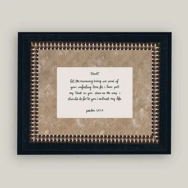Framed wall art with a handwritten Bible verse on a beige background