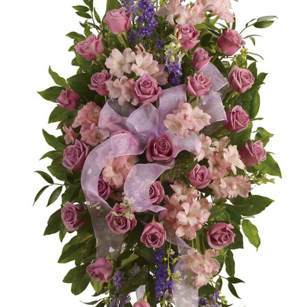 Standing floral spray with pink roses and lavender flowers on an easel