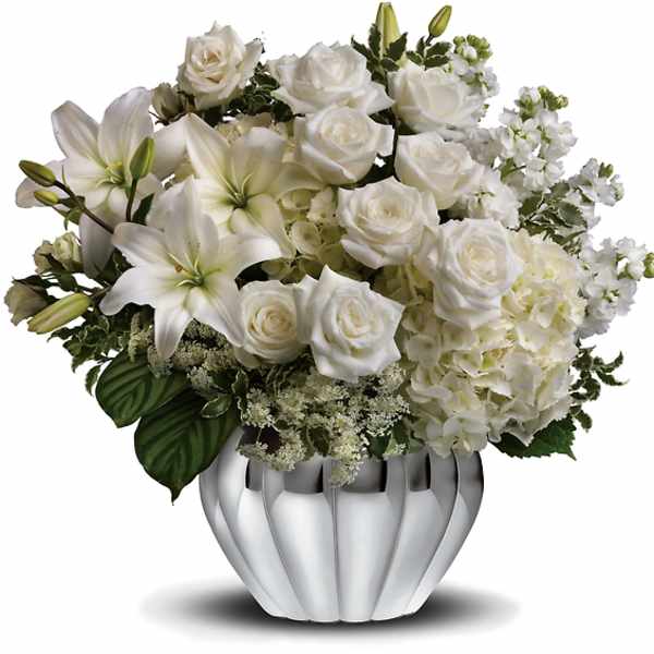 White roses and lilies arranged in a silver vase