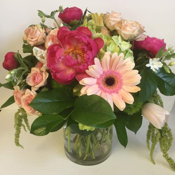 Bouquet of pink and peach flowers in a glass vase