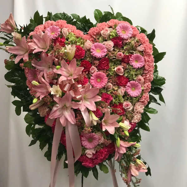 Heart-shaped pink floral standing spray with lilies and roses