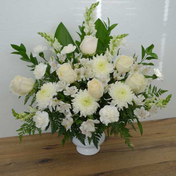 White roses and chrysanthemums arranged in a white vase
