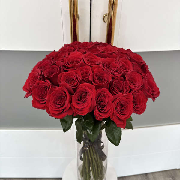 Large bouquet of red roses in a clear glass vase