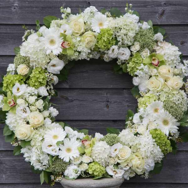 White and green floral wreath with roses and daisies