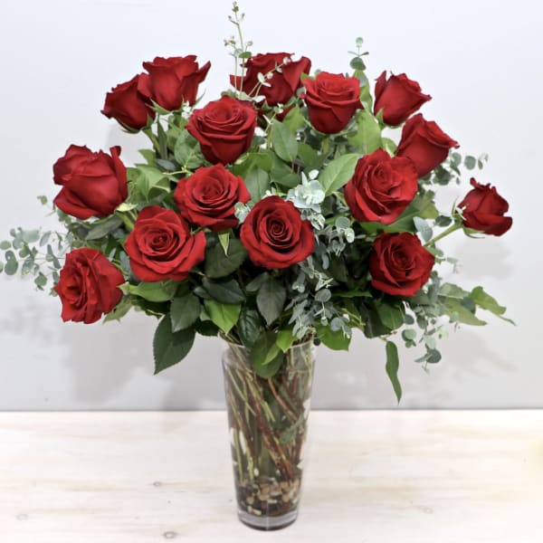 Bouquet of red roses in a tall clear glass vase