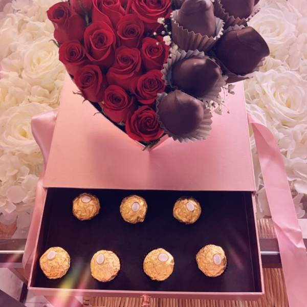 Heart-shaped box with red roses, chocolate-covered strawberries, and Ferrero Rocher chocolates