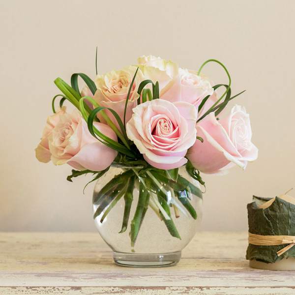 Pink roses arranged in a clear glass vase
