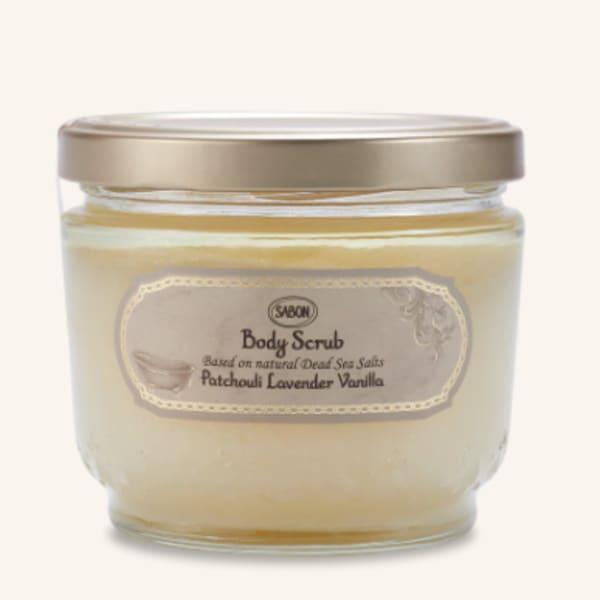 Jar of body scrub with a gold lid and beige label