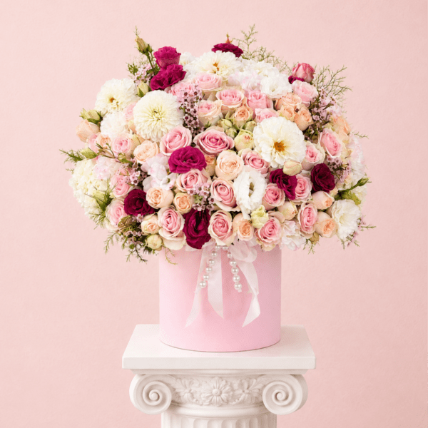 Pink and white rose bouquet in a pink hatbox with ribbon and pearls