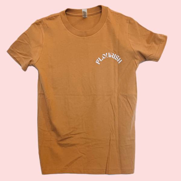 Tan T-shirt with "FLOURISH" printed on the chest