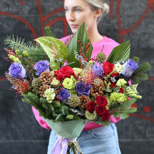 Large bouquet of red, purple, and green flowers with pinecones