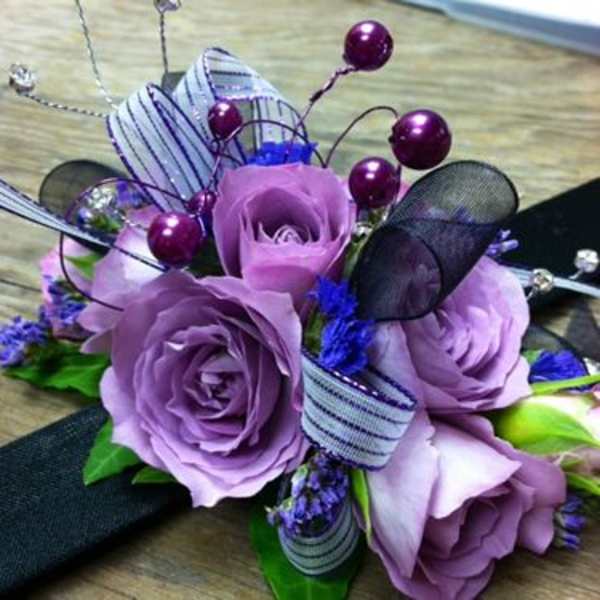 Lavender rose bouquet with purple accents and ribbon loops