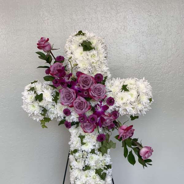 Cross-shaped floral tribute with white chrysanthemums and pink roses