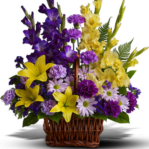 Basket arrangement of purple and yellow flowers with daisies and lilies