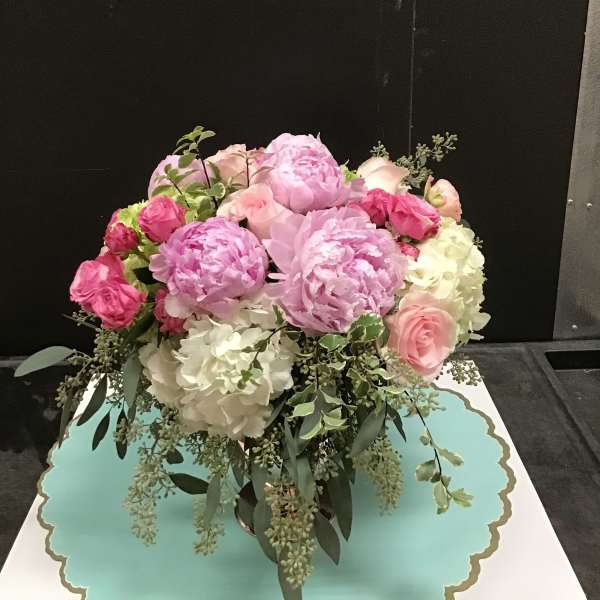 Pink and white floral arrangement in a vase