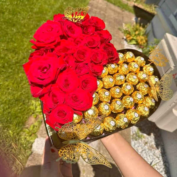 Heart-shaped box with red roses and gold-wrapped chocolates