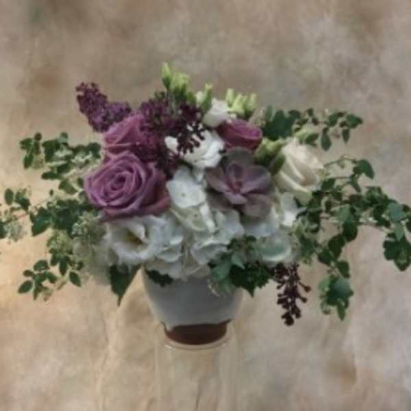 Bouquet of purple and white flowers in a vase