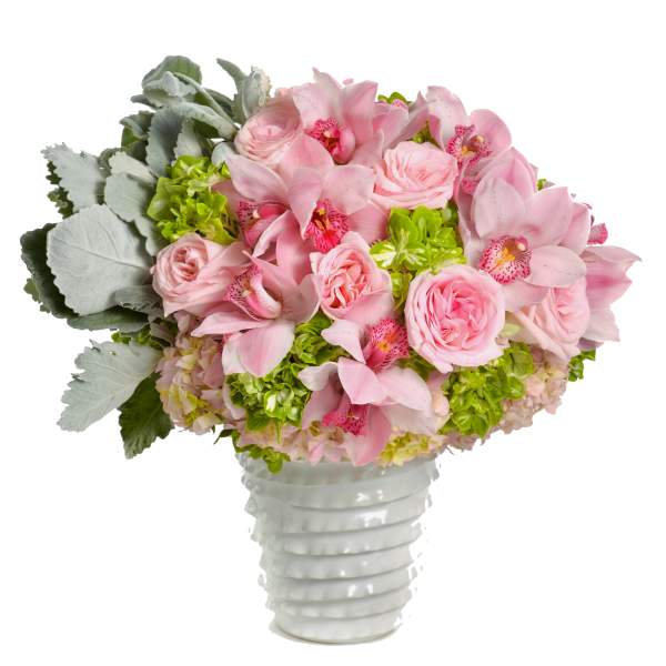 Pink roses and orchids arranged in a white vase
