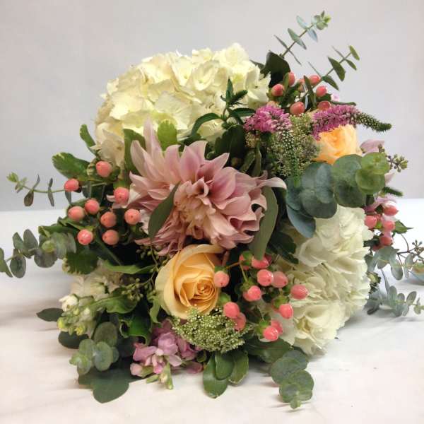 Bouquet of white and blush flowers with pink berries and eucalyptus