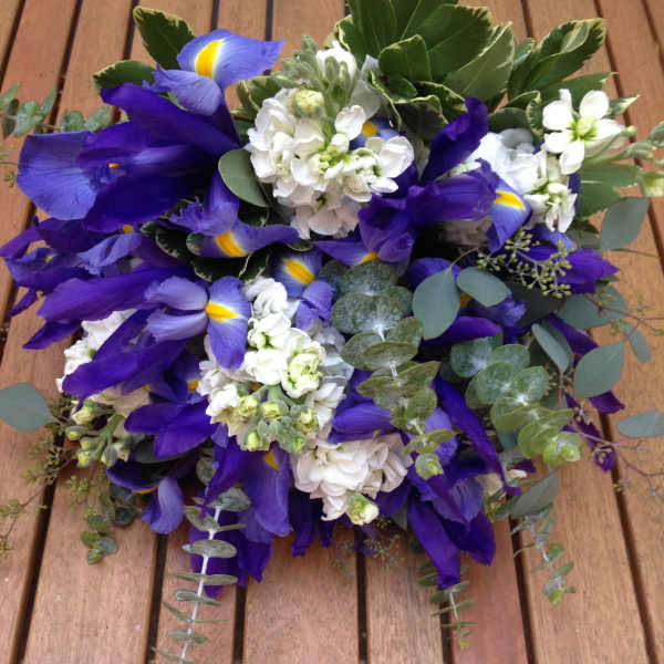 Bouquet of purple irises and white flowers with eucalyptus