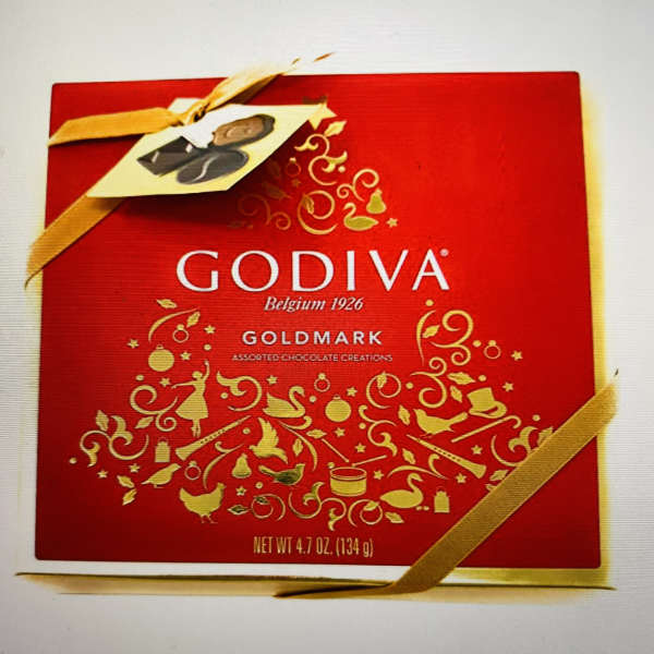 Red Godiva chocolate gift box with gold ribbon