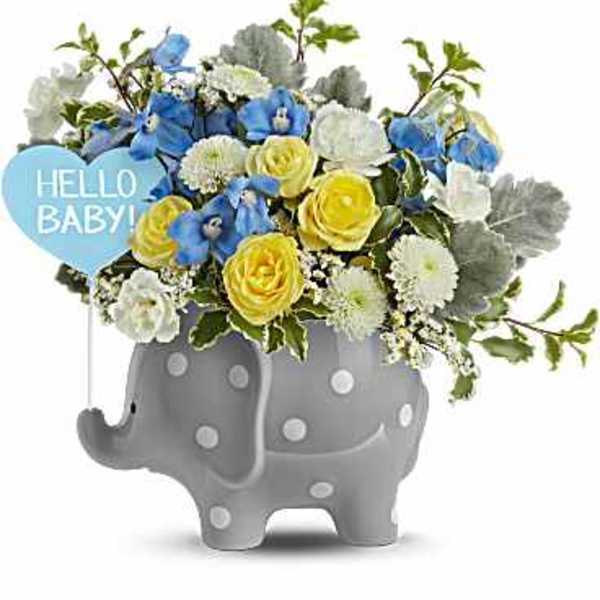 Blue and yellow flower arrangement in a gray elephant planter with a "Hello Baby!" sign