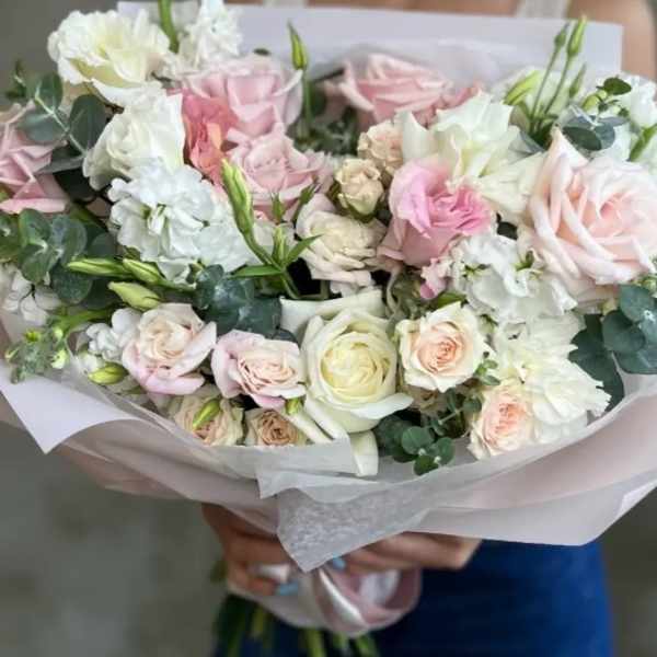 Hand-tied bouquet of pale pink and white roses with white blooms