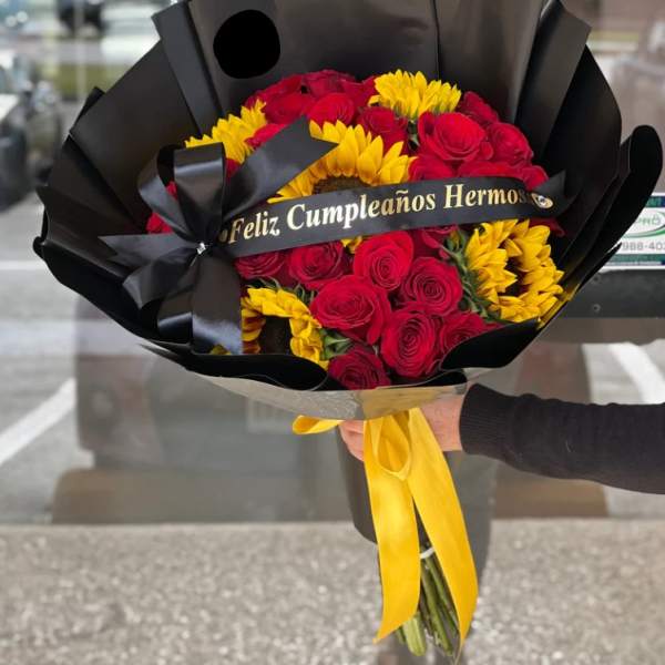 Bouquet of red roses and yellow sunflowers wrapped in black paper