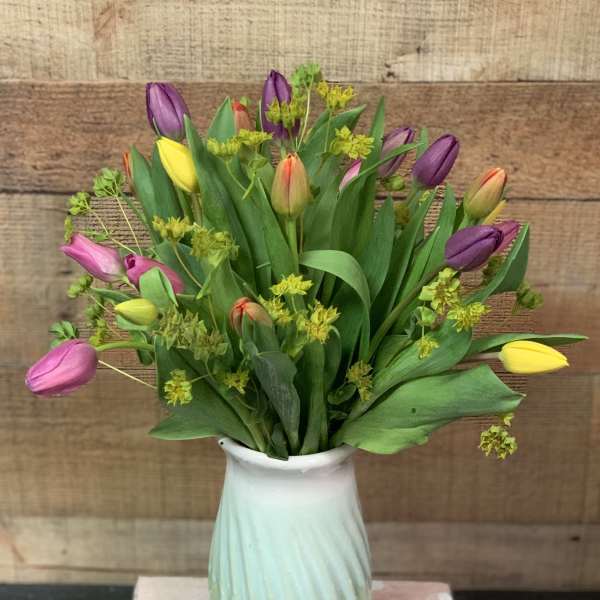 Bouquet of multicolored tulips in a white vase