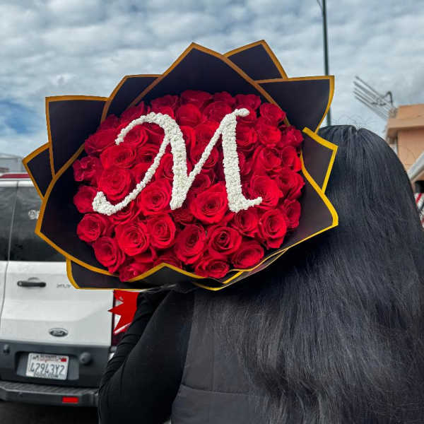 Large bouquet of red roses with a white letter M