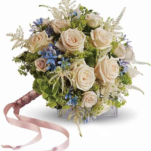 Bouquet of cream roses with blue accents and a pink ribbon handle