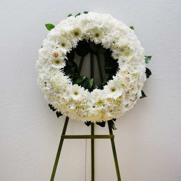 White floral wreath on a standing easel