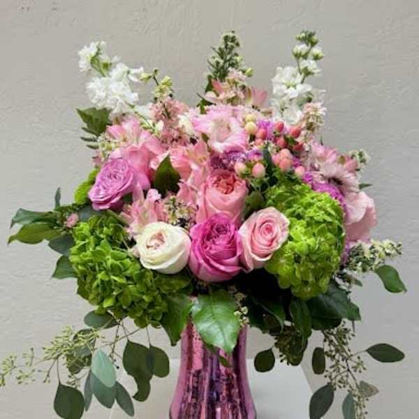 Pink and white mixed flower arrangement in a metallic vase