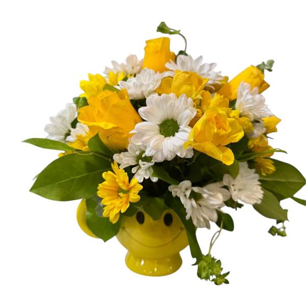 Yellow roses and white daisies in a smiley-face vase