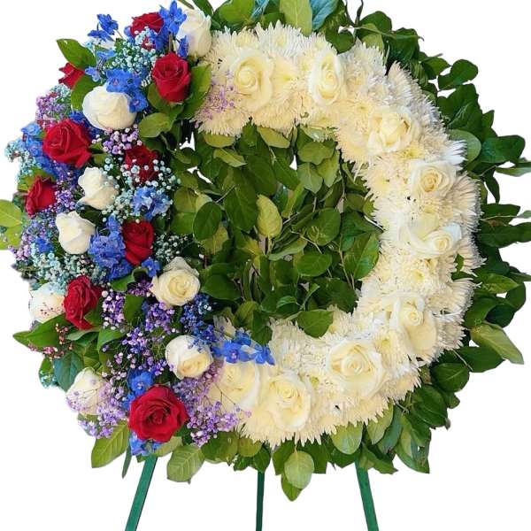 Heart-shaped floral wreath with red, white, blue, and purple flowers